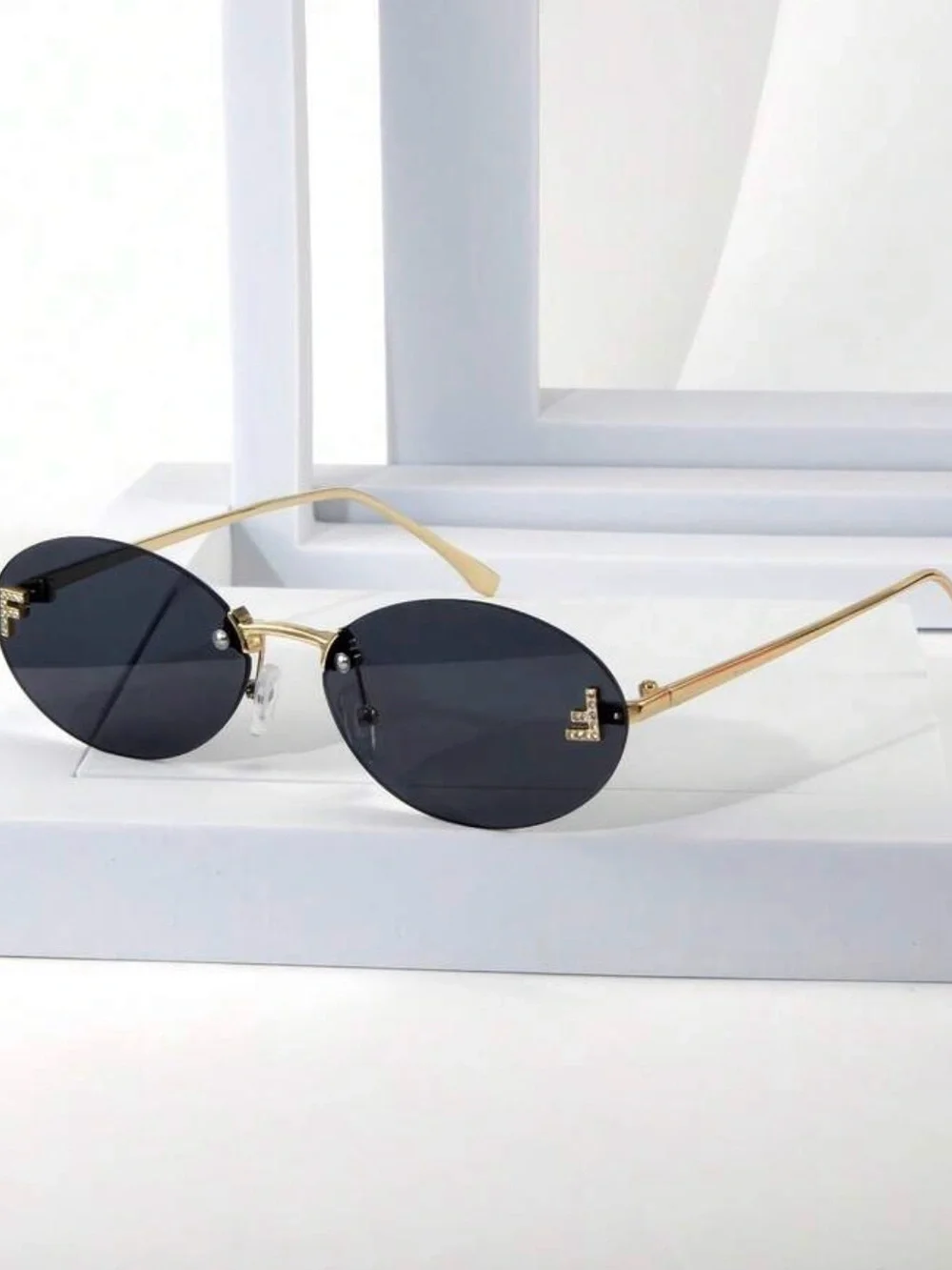 Rimless Oval Black Lens Sunglasses with Gold Temples